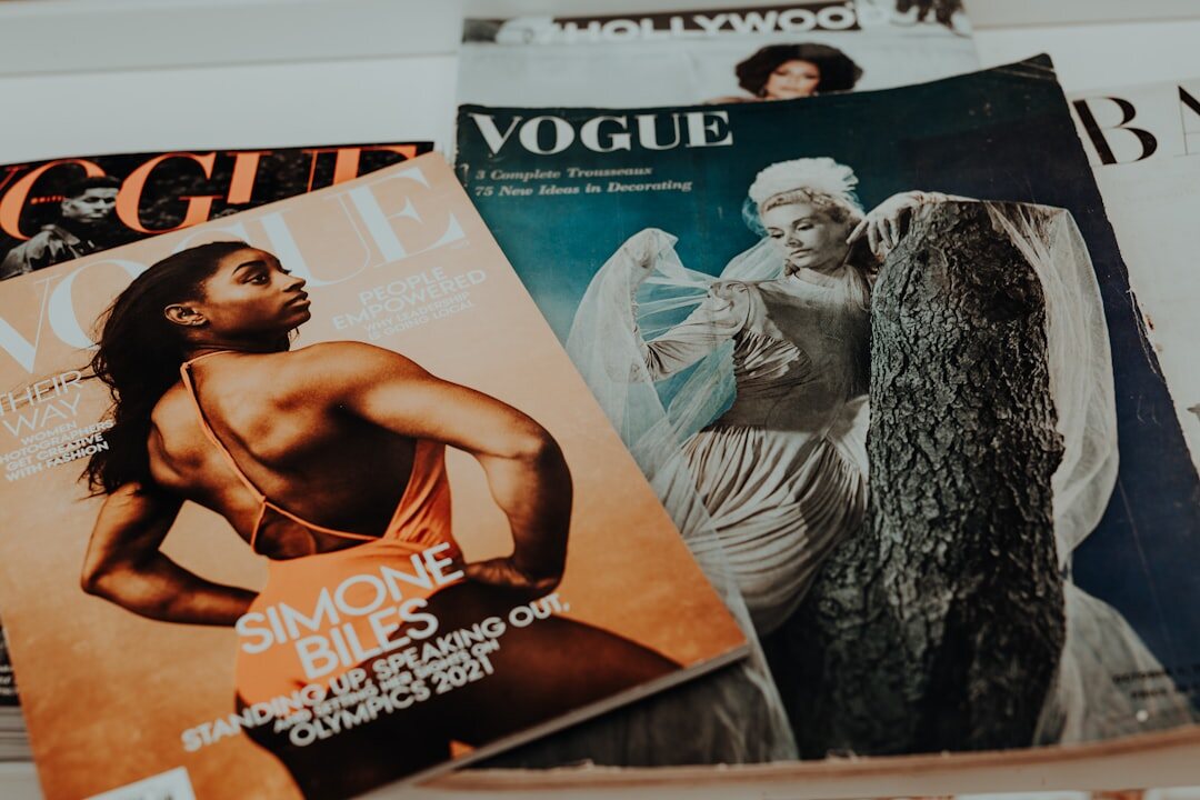 Stack of vintage magazines and printed advertisement pages